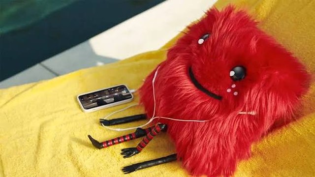 Scarlet lying by the pool with earbuds